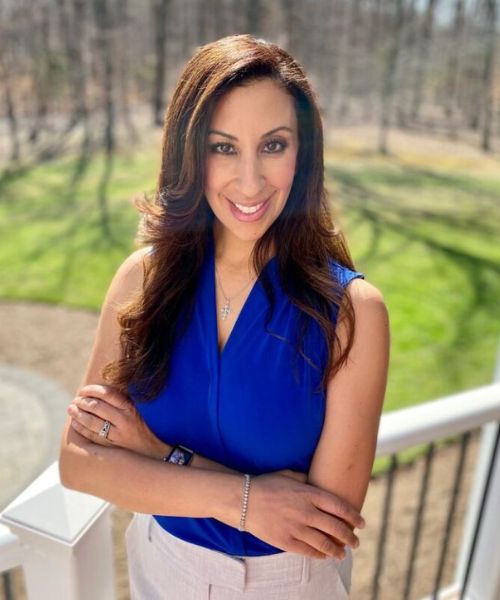 Dr. Nancy Selim standing outside and smiling with her arms crossed.