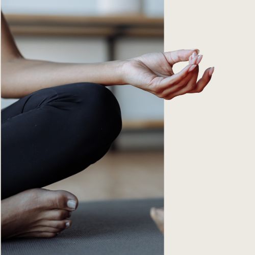 A woman's hand and leg folded in a yoga pose signifying the holistic approach taken by Dr. Selim's health coaching 